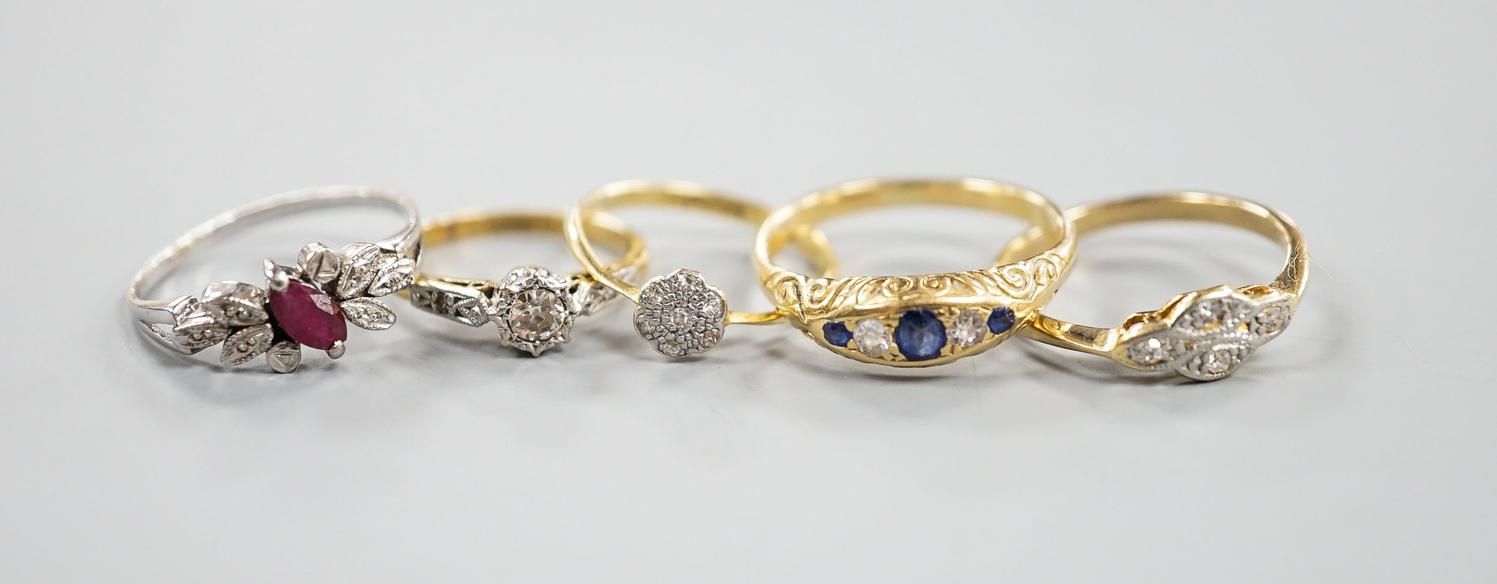 Two 18ct and diamond rings, including small cluster and single stone, sizes L & H, an 18ct sapphire and diamond ring, size O, gross 7.3 grams and two other yellow or white metal and gem set rings, gross 3.6 grams.